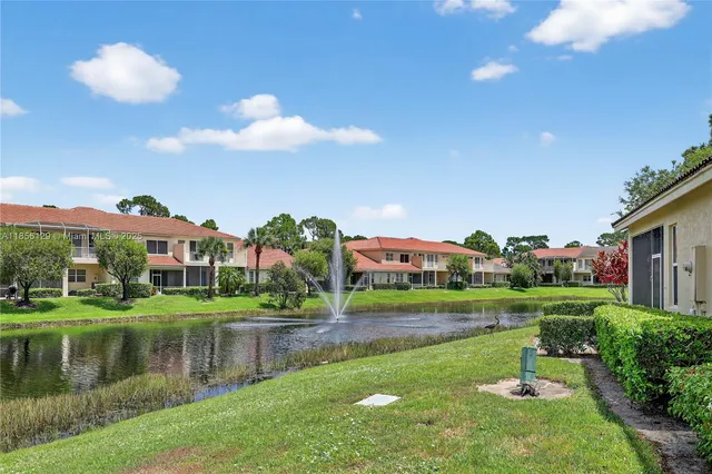 a front view of a house with yard and green space