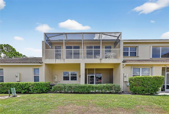 a view of building with lake and houses in back