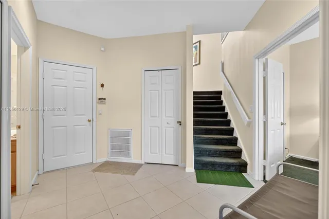 an aerial view of residential houses with outdoor space and lake view