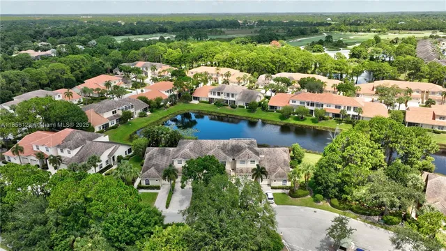an aerial view of residential houses with lake view
