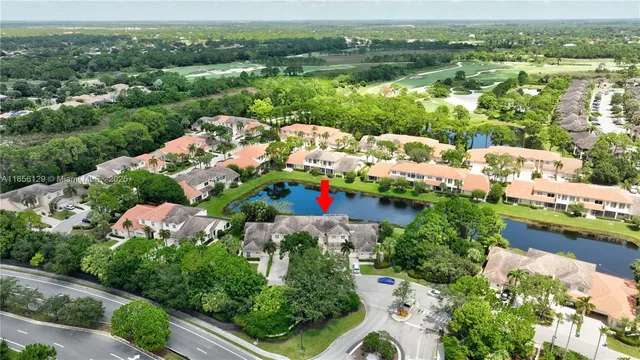 an aerial view of a house with a garden and lake view