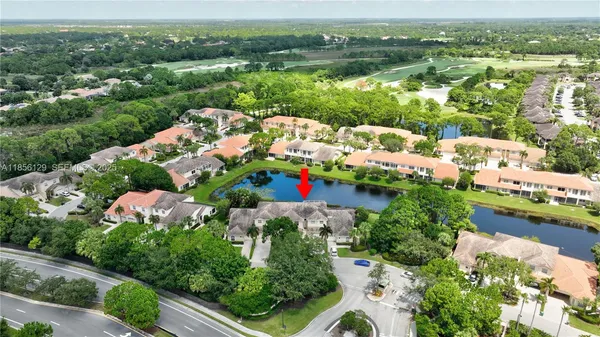 an aerial view of a house with a garden and lake view