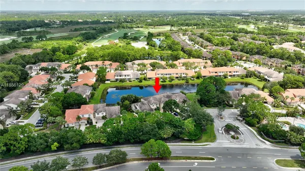 a aerial view of a house with swimming pool and green space