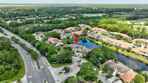 an aerial view of a house with a yard and outdoor seating