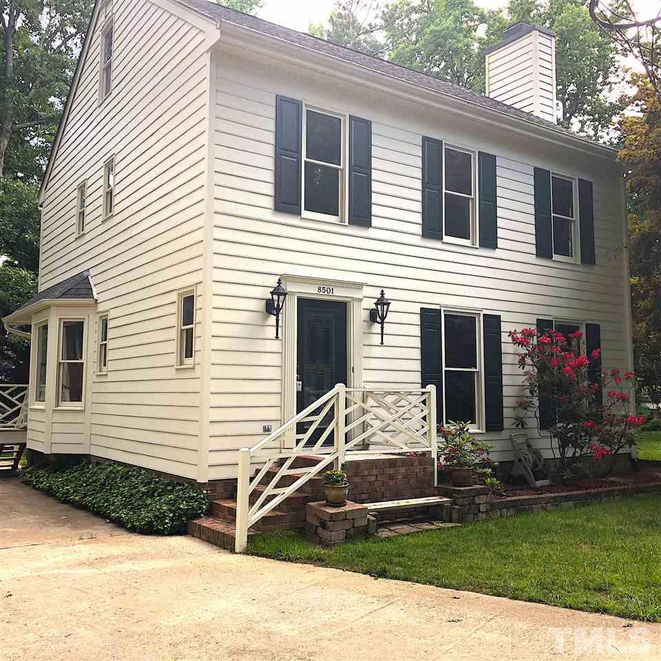 a view of a house with backyard and porch