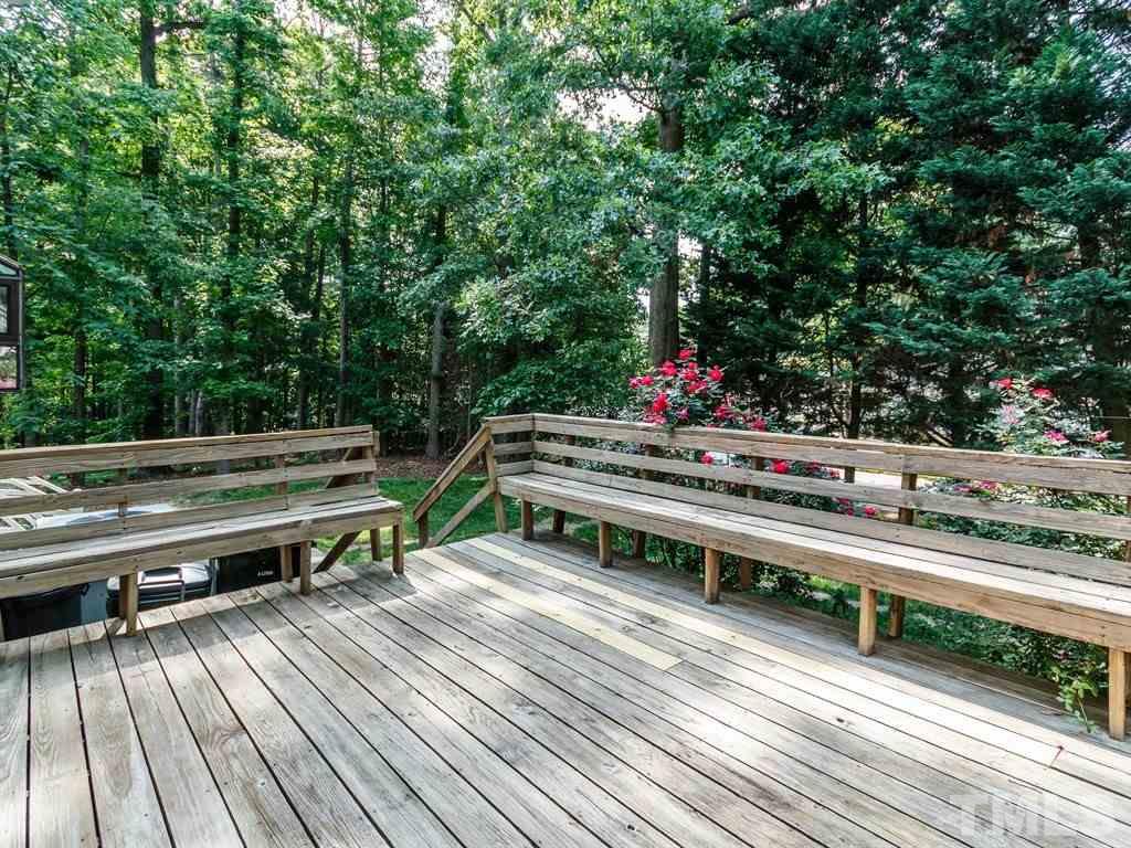 8501 Council Court Raleigh, NC 27615 - Photo 11 of 19 a backyard of a house with wooden floor and outdoor seating