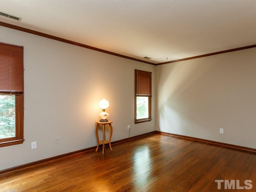 8501 Council Court Raleigh, NC 27615 - Photo 12 of 19 a view of empty room with wooden floor and fan
