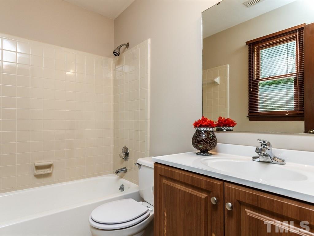 8501 Council Court Raleigh, NC 27615 - Photo 15 of 19 a bathroom with a sink a toilet and shower