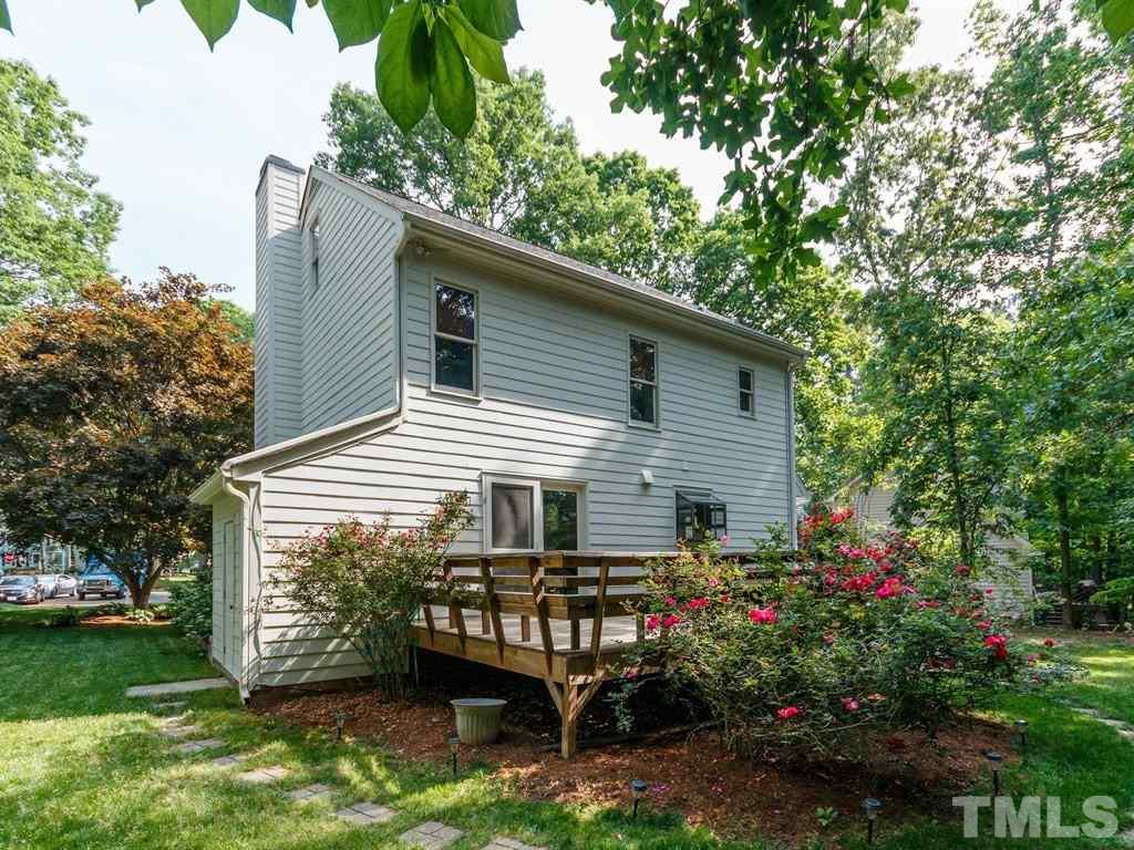 8501 Council Court Raleigh, NC 27615 - Photo 10 of 19 a backyard of a house with wooden deck and trees