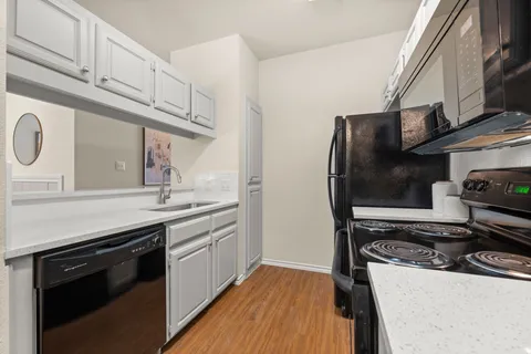 a kitchen with stainless steel appliances granite countertop a stove and a refrigerator