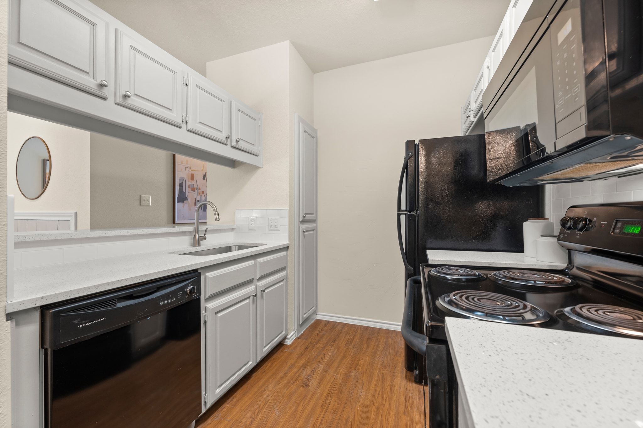 914 West 26th Street, Unit 202 Austin, TX 78705 - Photo 11 of 34 a kitchen with stainless steel appliances granite countertop a stove and a refrigerator