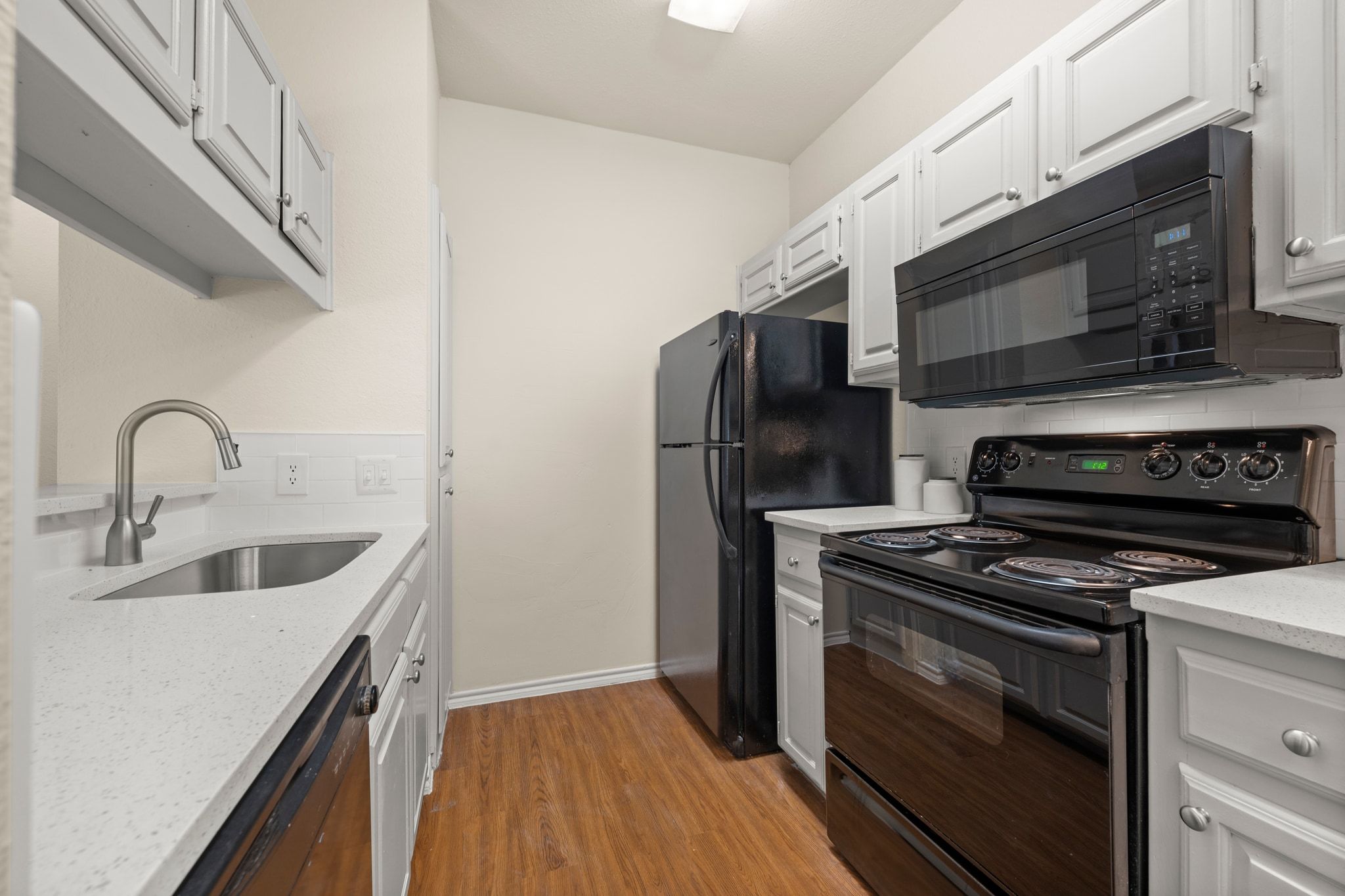 914 West 26th Street, Unit 202 Austin, TX 78705 - Photo 12 of 34 a kitchen with stainless steel appliances a stove a microwave and a sink