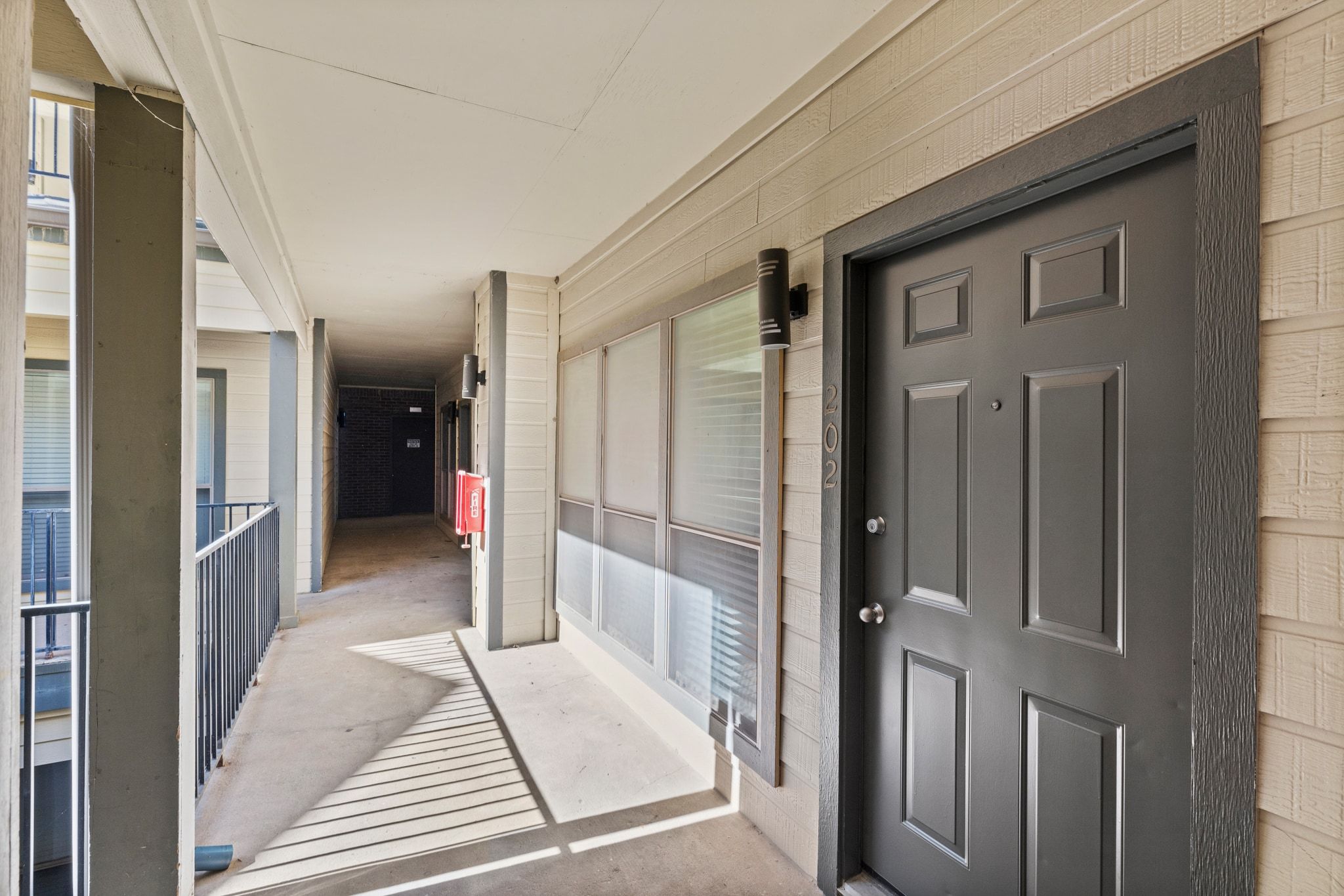 914 West 26th Street, Unit 202 Austin, TX 78705 - Photo 3 of 34 a view of a hallway with wooden floor and a living room