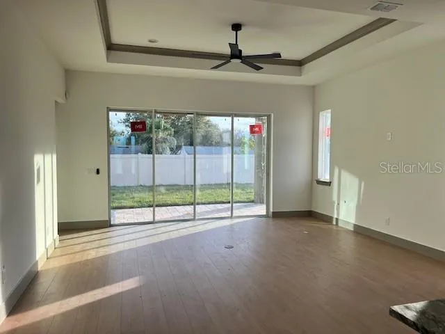 a view of a room with wooden floor and windows