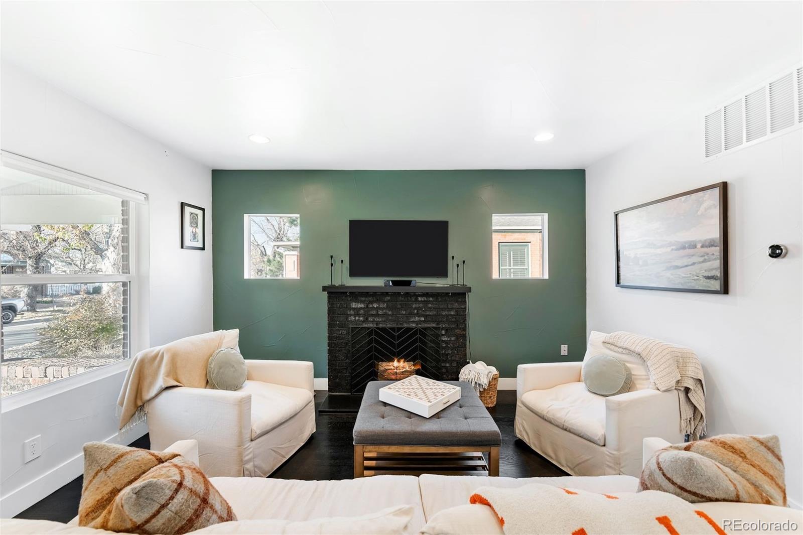 4270 Irving Street Denver, CO 80211 - Photo 11 of 34 a living room with furniture a flat screen tv and a fireplace