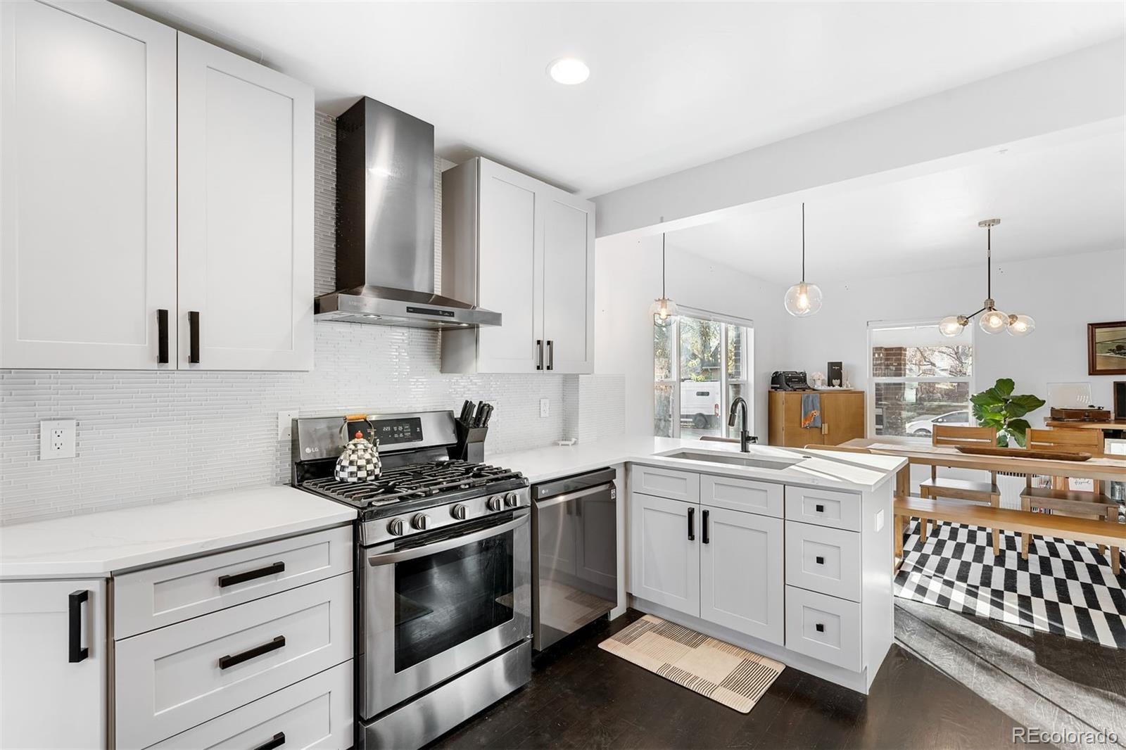 4270 Irving Street Denver, CO 80211 - Photo 16 of 34 a kitchen with white cabinets and appliances
