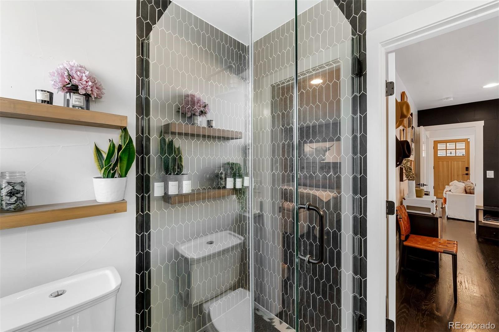 4270 Irving Street Denver, CO 80211 - Photo 21 of 34 a bathroom with a toilet a sink and glass door