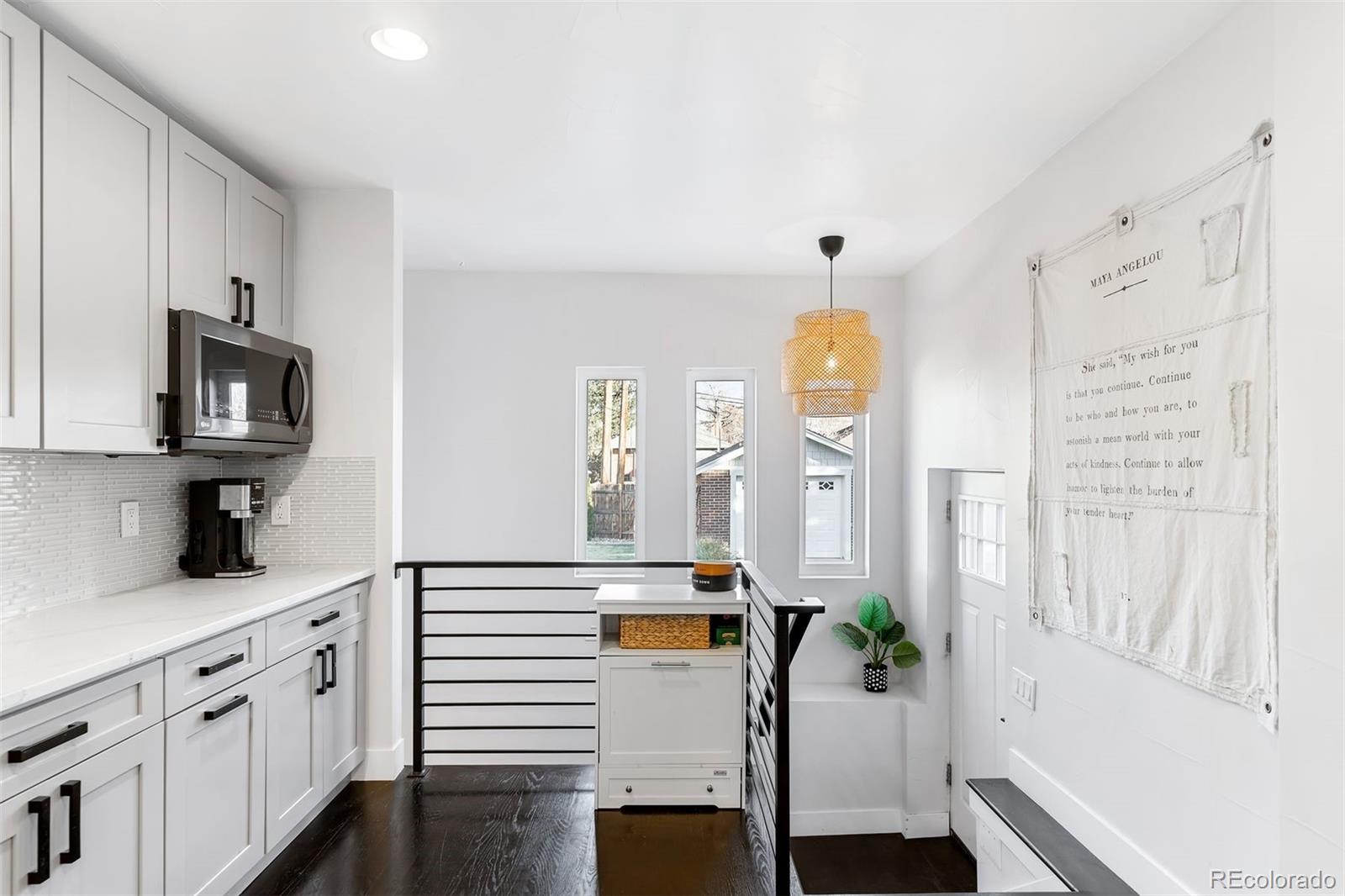 4270 Irving Street Denver, CO 80211 - Photo 23 of 34 a kitchen with stainless steel appliances a white cabinets wooden floors and a sink