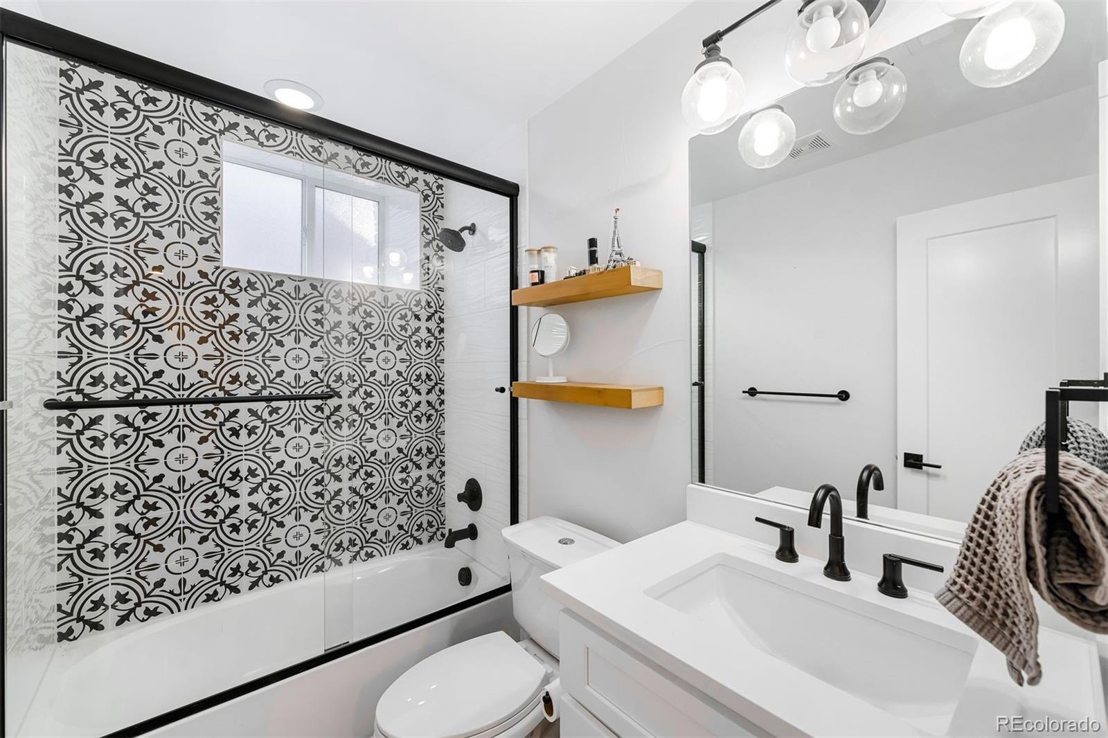 4270 Irving Street Denver, CO 80211 - Photo 27 of 34 a bathroom with a sink toilet and shower