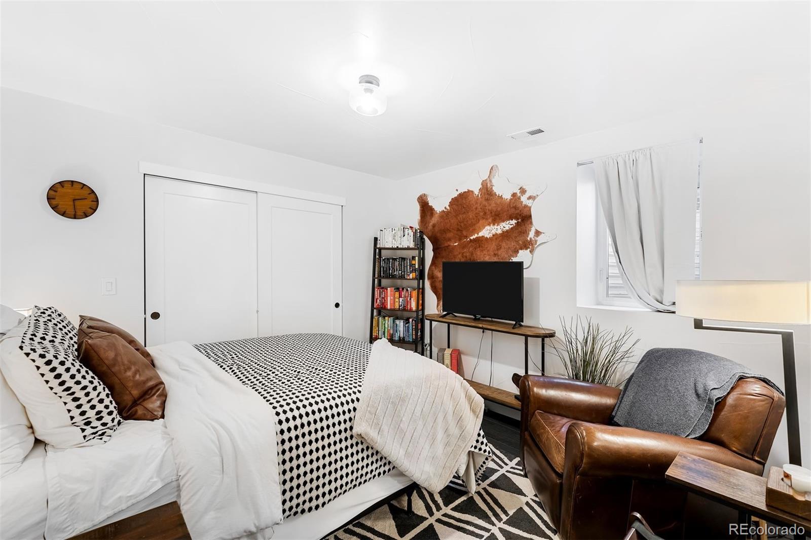 4270 Irving Street Denver, CO 80211 - Photo 28 of 34 a bedroom with furniture and a flat screen tv