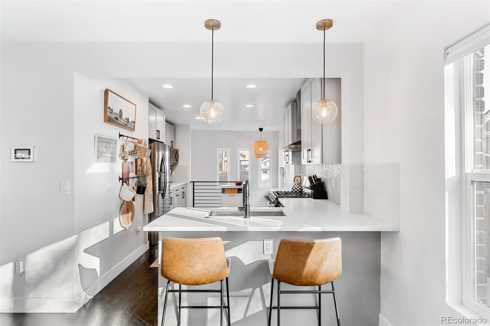 4270 Irving Street Denver, CO 80211 - Photo 3 of 34 a dining table chairs and a chandelier