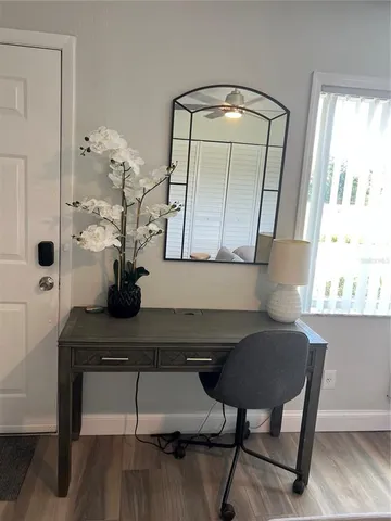 a view of hall way with furniture and window