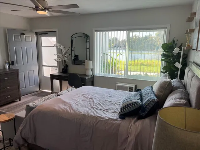 a bedroom with a bed window and a potted plant