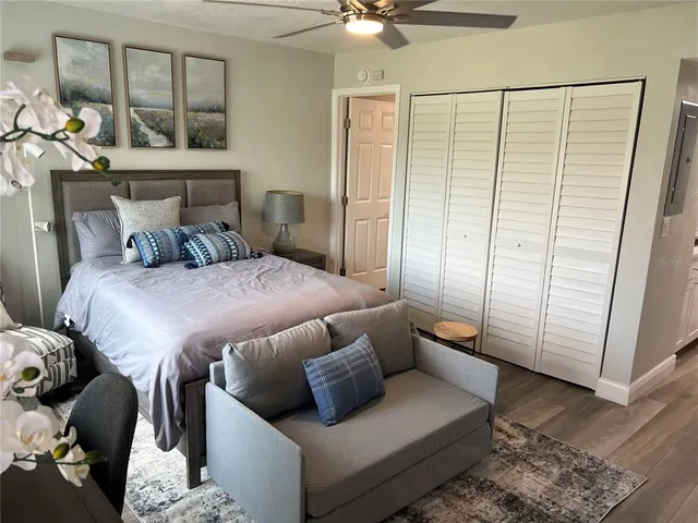 a bedroom with a bed a couch and a window