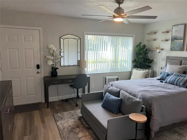 a bedroom with a bed and a chandelier