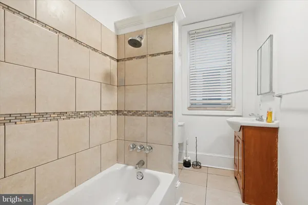 a bathroom with a bathtub and shower