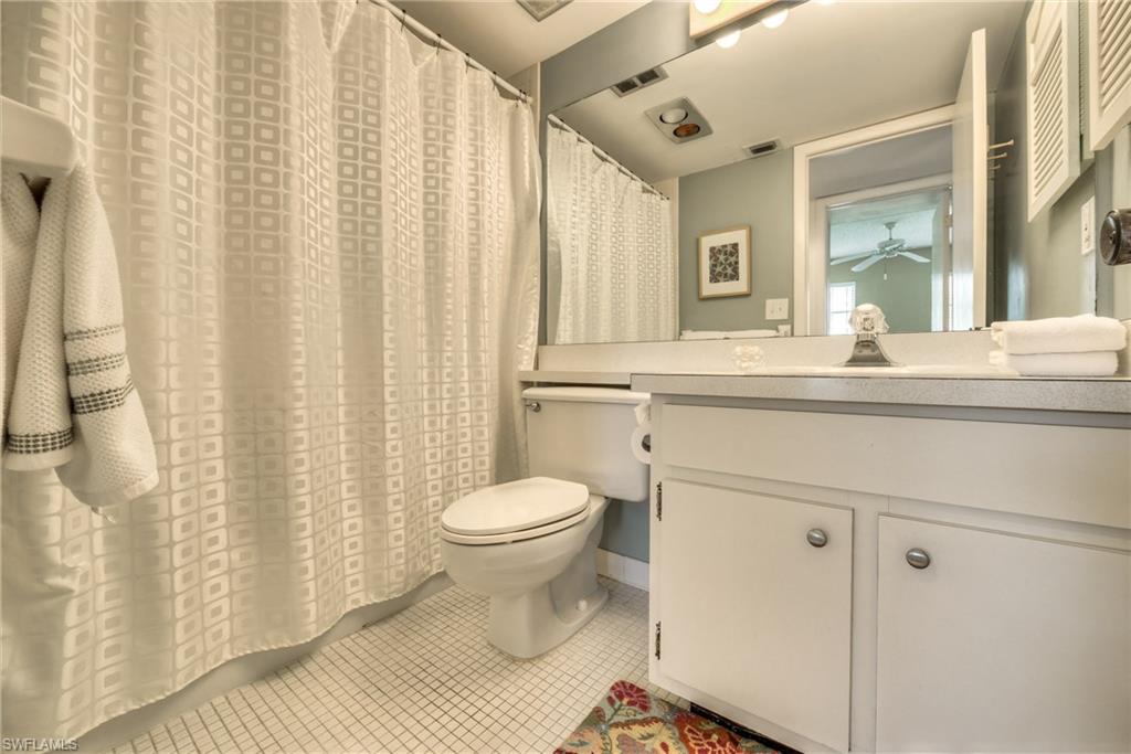 113 Bobolink Way, Unit 113B Naples, FL 34105 - Photo 12 of 15 a bathroom with a sink toilet and shower