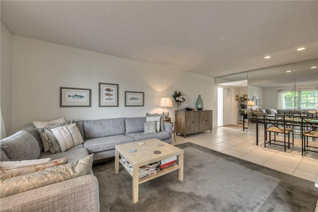 113 Bobolink Way, Unit 113B Naples, FL 34105 - Photo 4 of 15 a living room with furniture and kitchen view