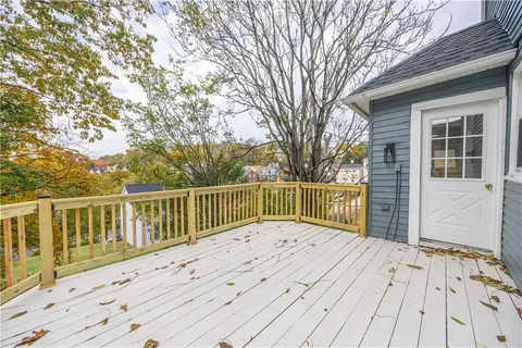 a view of a house with wooden fence
