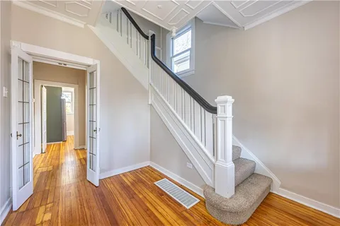 a view of entryway and hall with wooden floor
