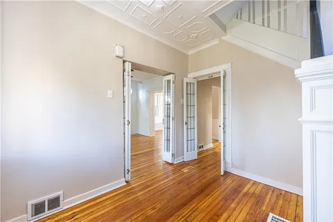 a view of hallway with wooden floor