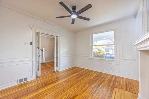 wooden floor in an empty room with a window