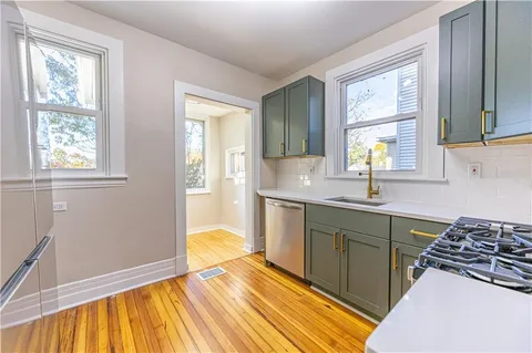a spacious bathroom with a sink a mirror and next to a window