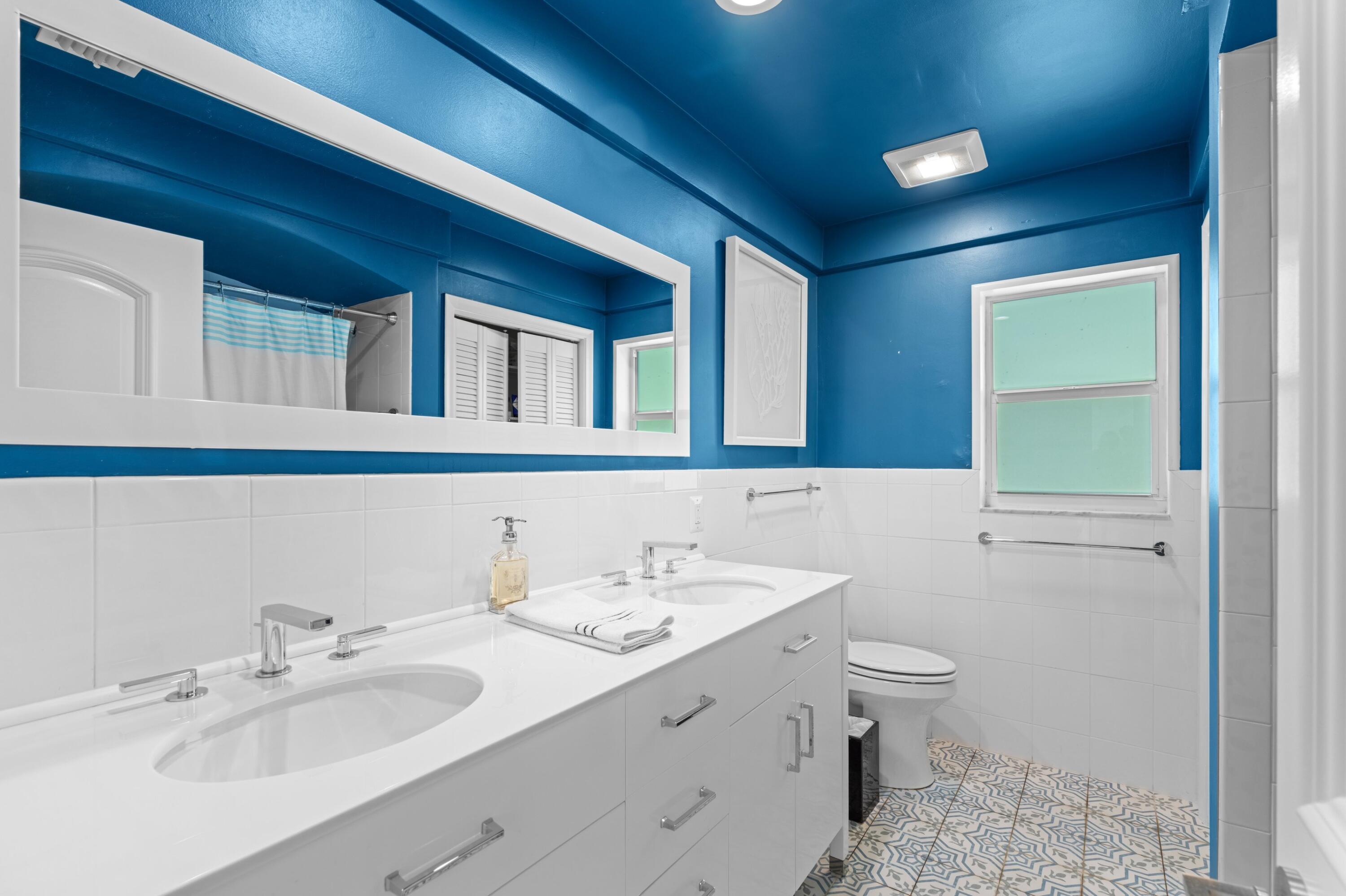 200 Ellamar Road West Palm Beach, FL 33405 - Photo 16 of 20 a bathroom with a sink and a mirror