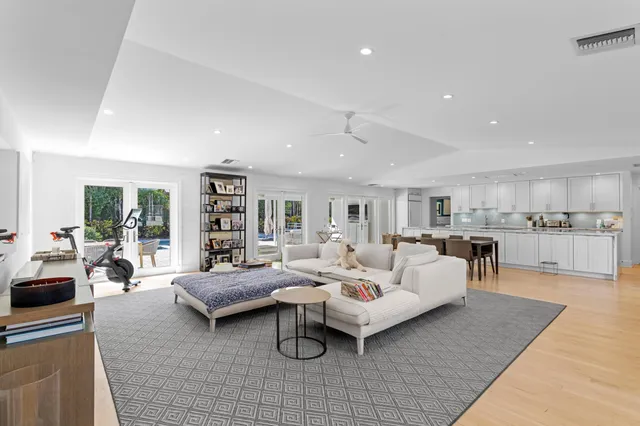 a living room with furniture and view of kitchen