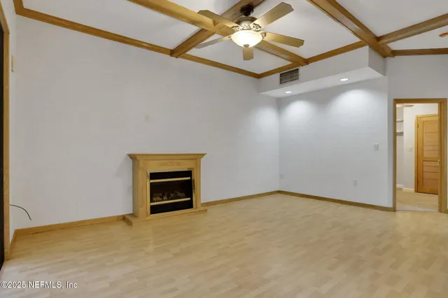 a view of an empty room with a cabinet