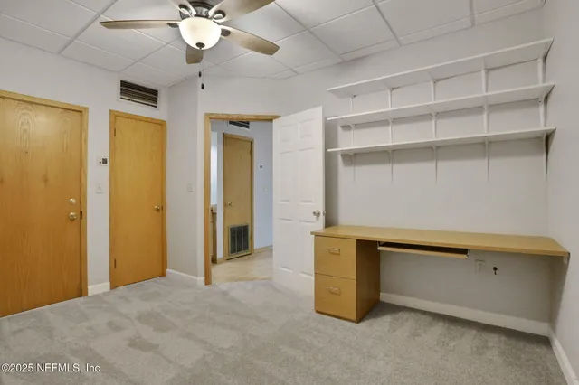 a view of a hallway with wooden floor and glass door