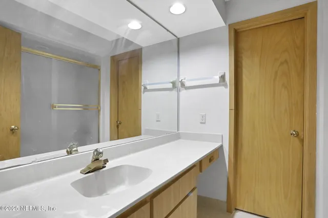a bathroom with a glass shower door