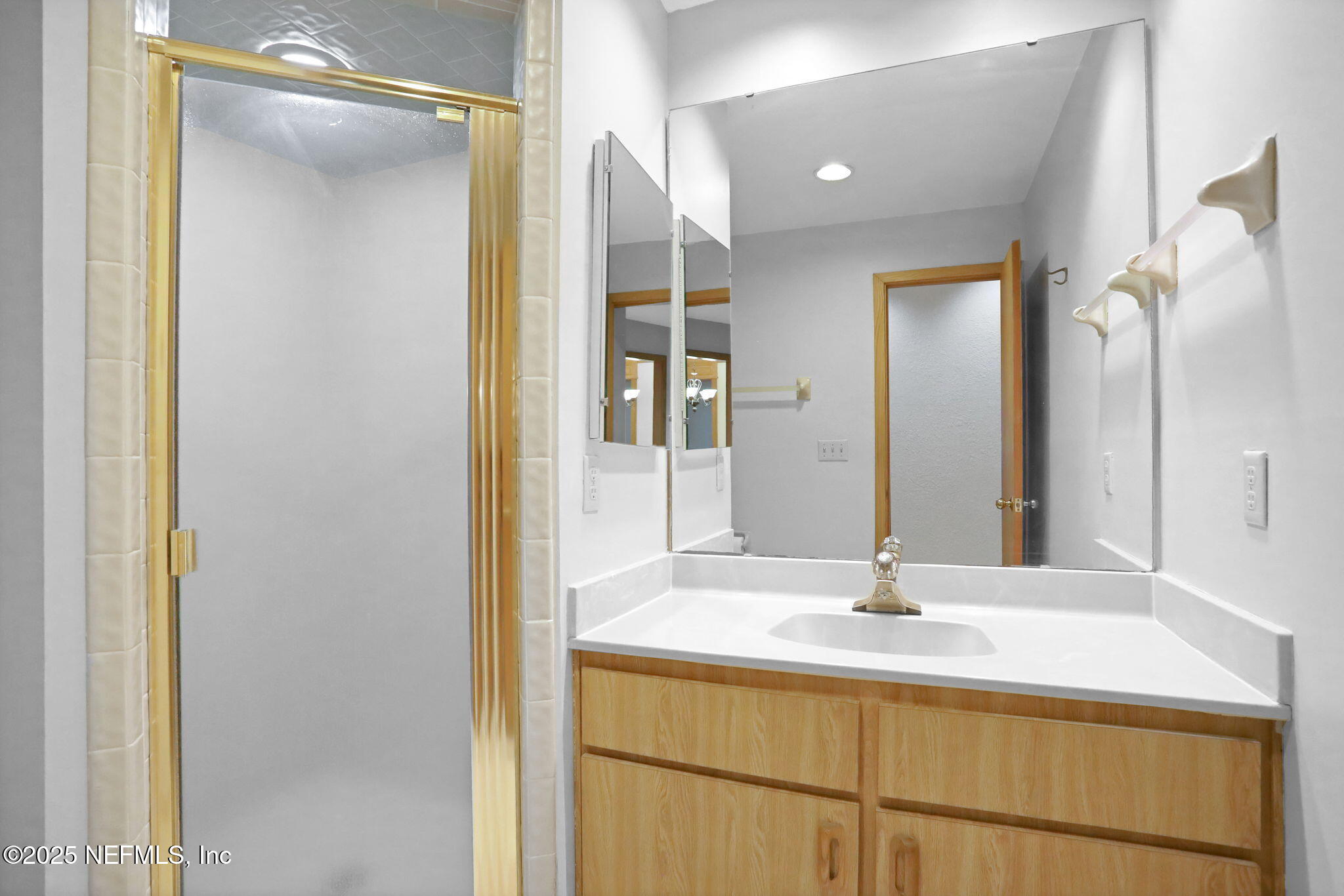 2970 Ravines Road, Unit 1308 Middleburg, FL 32068 - Photo 29 of 33 a bathroom with a sink and a mirror