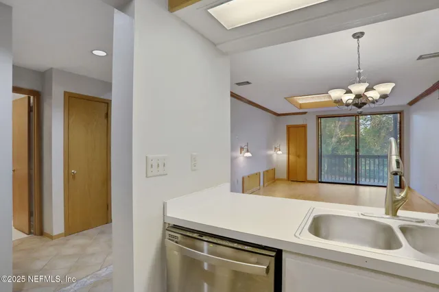 a kitchen with a sink and chandelier