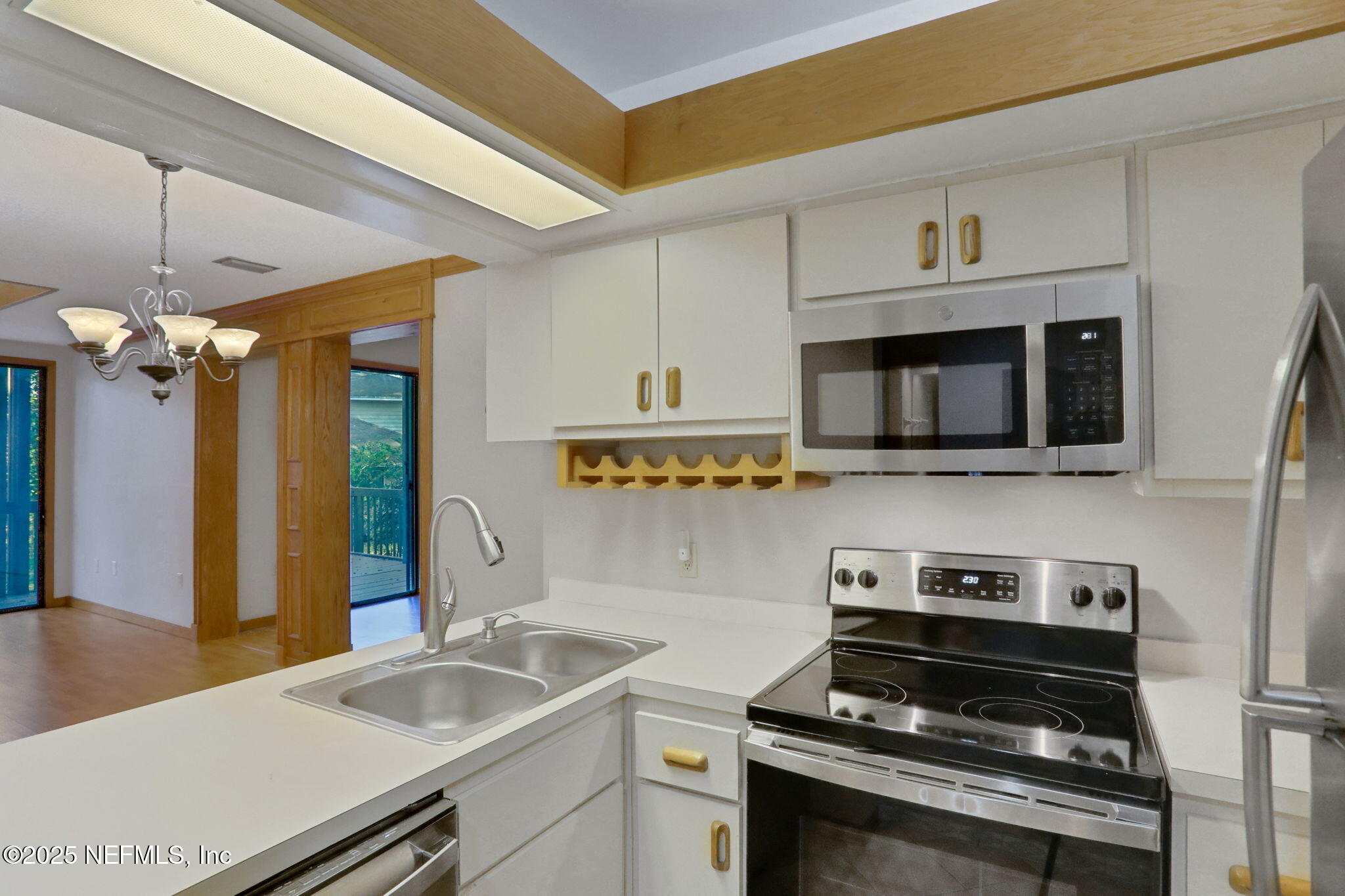 2970 Ravines Road, Unit 1308 Middleburg, FL 32068 - Photo 7 of 33 a kitchen with stainless steel appliances a sink a stove and microwave