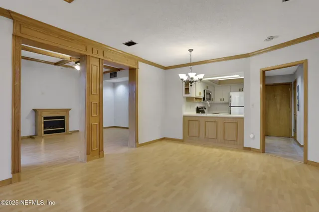 a view of a kitchen with a sink and a fireplace