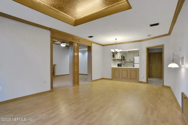a view of a kitchen with a sink and a refrigerator