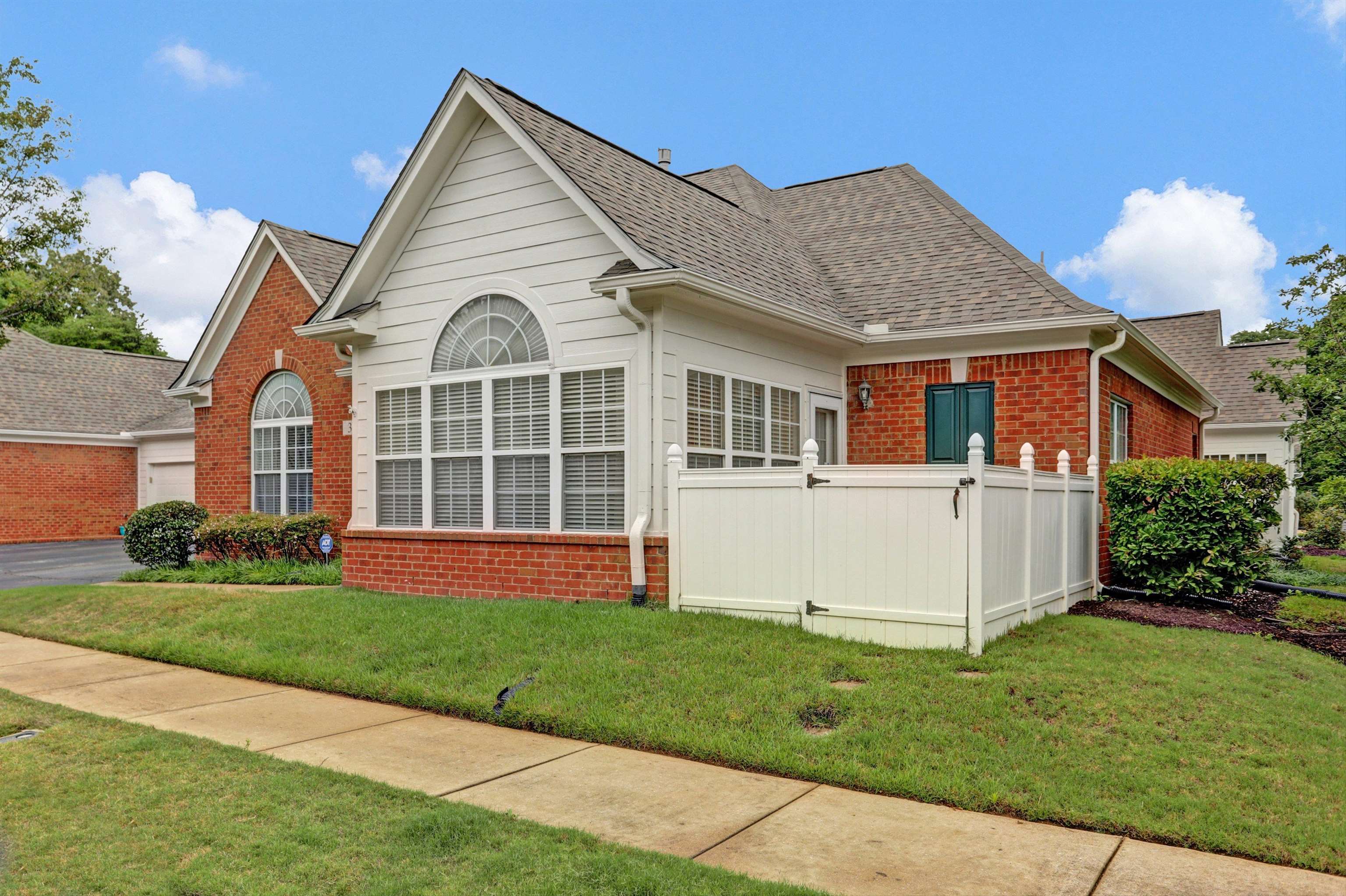 34 Peyton Ridge Drive, Unit 21 Collierville, TN 38017 - Photo 3 of 37 Brick and siding exterior featuring gabled roofs and arched transom windows