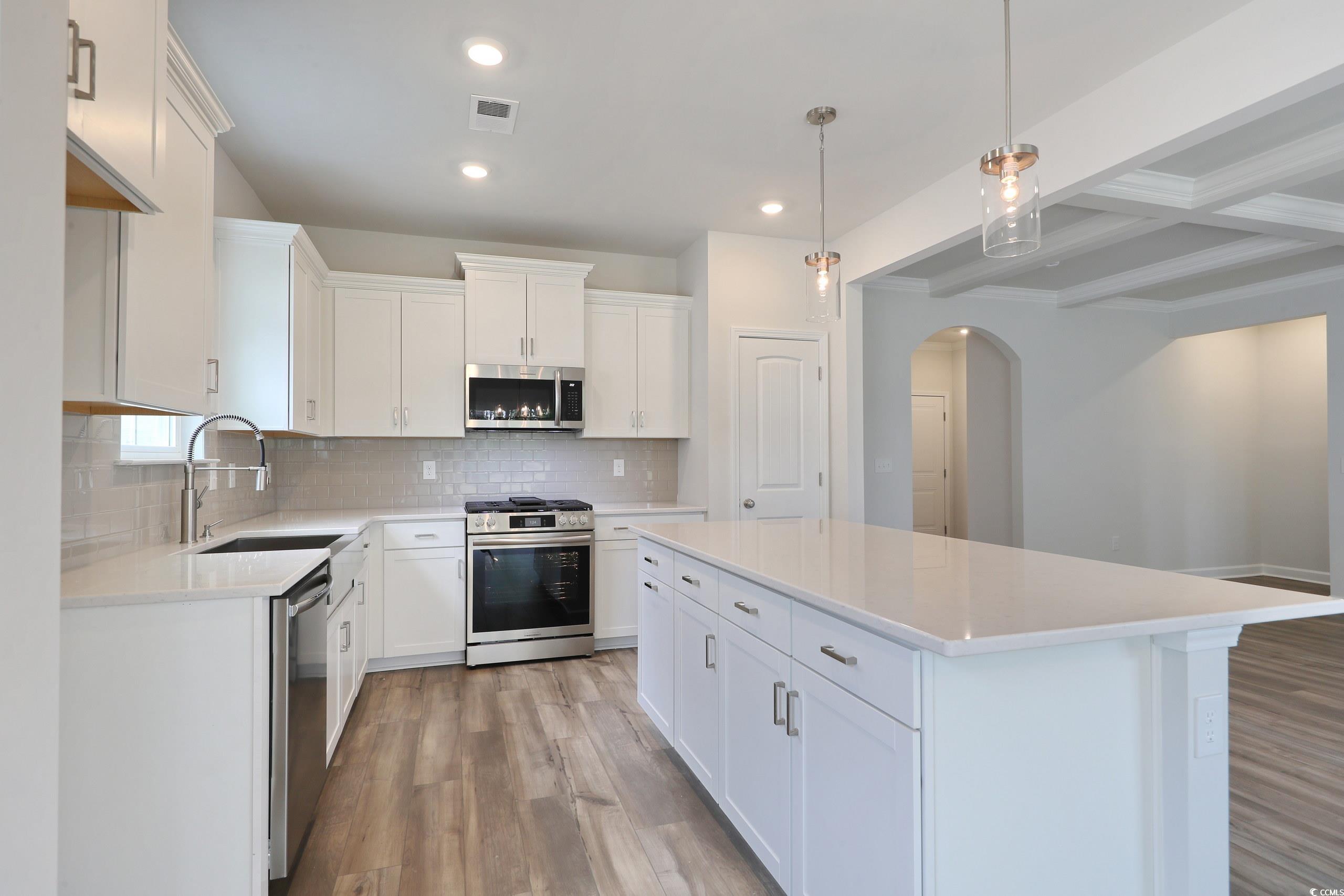 160 Azure Loop Myrtle Beach, SC 29588 - Photo 13 of 36 Kitchen featuring sink, a kitchen island, white ca