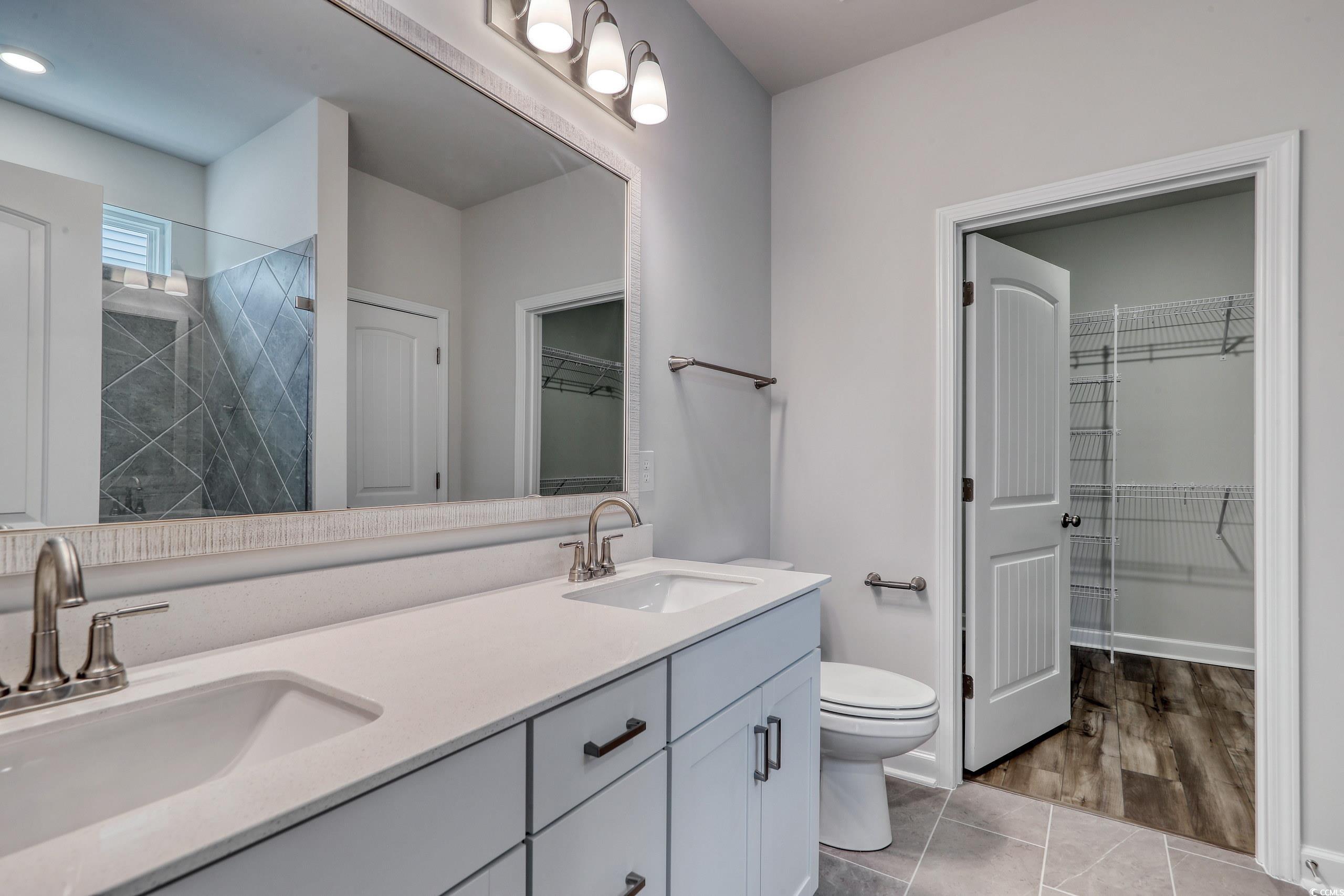 160 Azure Loop Myrtle Beach, SC 29588 - Photo 17 of 36 Bathroom with wood-type flooring, a tile shower, v